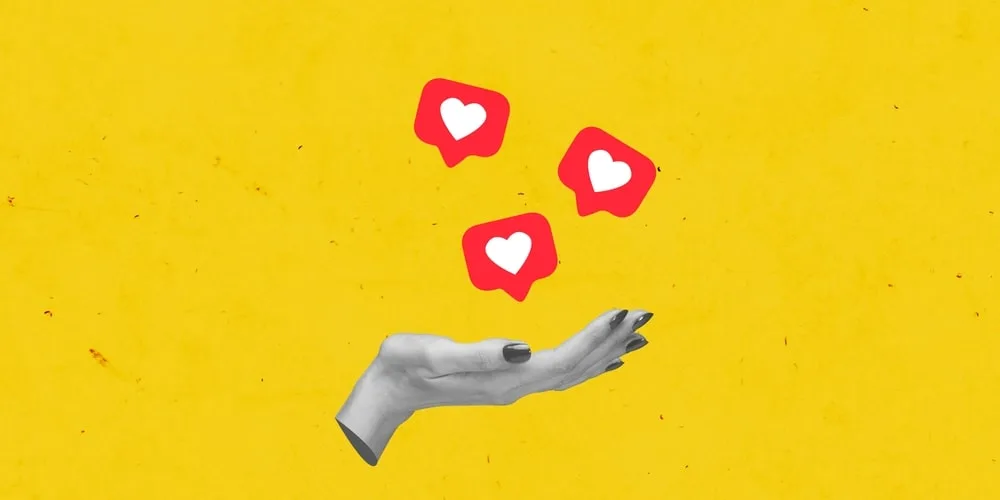 Hand reaching up with red heart icons on bright yellow background representing social media engagement and digital marketing