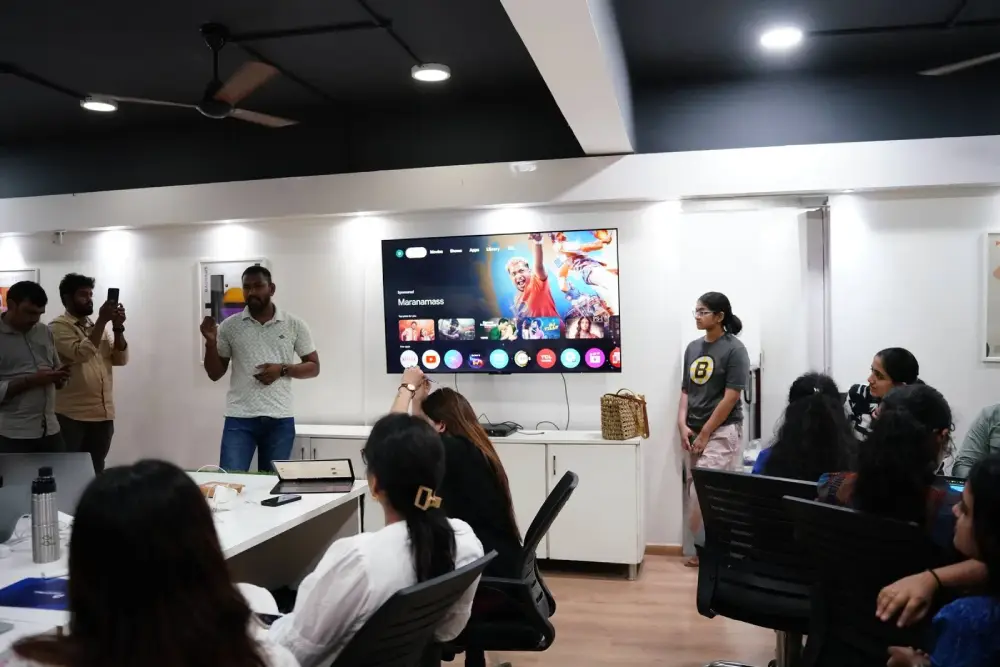 Team training session at Digital Mojo office with employees watching presentation on smart TV screen